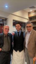 Actor Eugene Levy (right) and bandleader/musician Paul Shaffer (left) with restaurant owner Dennis Lekic at Benny John’s restaurant.