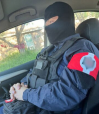 A photo that reportedly depicts Hayden Espinosa wearing a blurred-out swastika arm patch. Espinoza, a right-wing extremist, has been indicted for selling weaponry to an undercover cop– from federal prison.