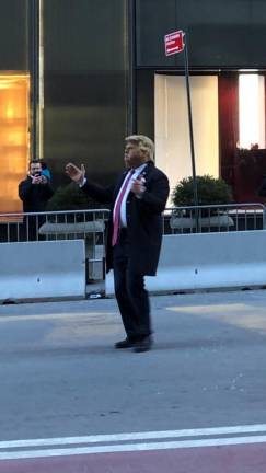 <b>Tourists rushed to capture photos of a Donald Trump impersonator on Fifth Ave. outside the Trump Tower on Feb. 18, two days after a judge handed down hefty penalties in the civil fraud trial of the real Donald Trump and his companies.</b> Photo: Keith J. Kelly