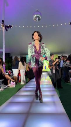 Julia Haart strikes a pose on the ramp before the show begins. she’s a fashion designer and entrepreneur who gained widespread attention through the Netflix series “<i>My Unorthodox Life</i>,” chronicling her personal and professional journey from leaving an ultra-Orthodox Jewish community to a businesswoman.