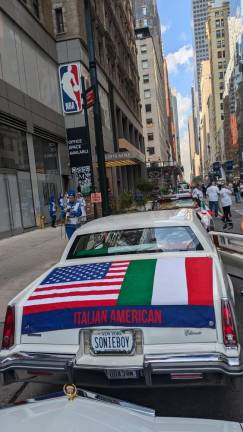 New York state license plate SONIEBOY from La Famiglia Cadillac Club waits to enter the line of march.