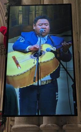 <b>A celebrant plays the bajo sexto, a 12 string Spanish instrument, as part of the celebration of Our Lady of Guadalupe, the patron saint of Mexico at St. Patrick’s Catheral on Dec. 12.</b> Photo: Brian Berger