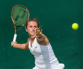 Annika Beck competing in the second round of the 2015 Wimbledon Qualifying Tournament at the Bank of England Sports Grounds in Roehampton, England.