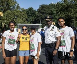 Tania Kinsella in yellow NYPD Running Club singlet at the Percy Sutton 5K Run.