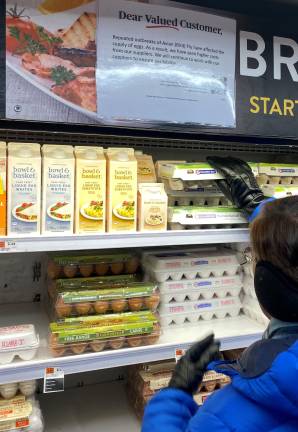 A shopper reaches for a carton of eggs at the Fairway on the Upper West Side.