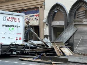 Twisted metal and wood outside an office building on West 29th between Eighth and Seventh Ave. on November 18 where a box truck tore down a scaffolding shed and injured three people, one seriously.