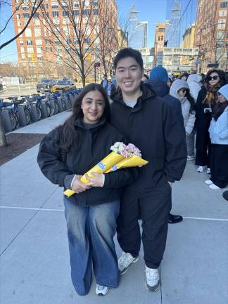 The three hour wait to get inside the pop up store was worth it for these happy fans, who left bouquets of caranations and roses.