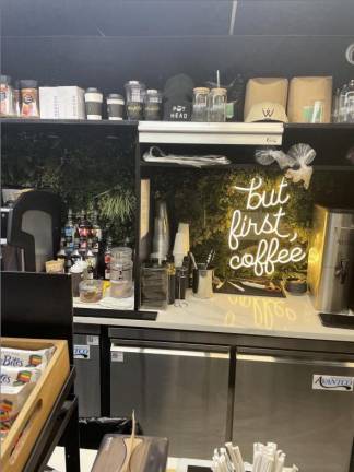 A sign reading, “but first coffee” adorns Winfield Street Coffee in its E. 72nd St. cafe inside the Q train subway station. Photo: Zachary Weg