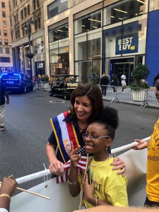 Governor Kathy Hochul embraces 8 year old Madison Dennie at the start of the Labor Day parade. Photo: Keith J. Kelly