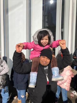 <b>Four year old Daijsel Cholula gets a great view of the floats perching on the shoulders of her dad Chris Choula She says her favorite balloons are Stuart the Minion and Paw Patrol</b> Photo: Keith J. Kelly