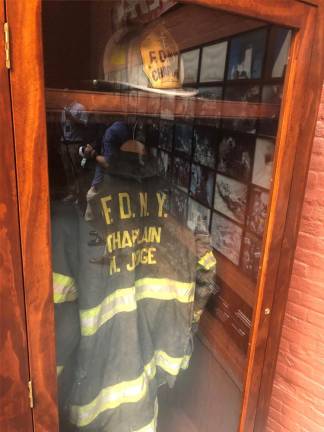 The turnout coat of FDNY Chaplain Father Mychal Judge, who became victim #1 on 9/11, is among the artifacts on display in the Fire Museum on Spring St. Photo: Keith J. Kelly