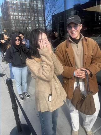 Camera-shy fan Ma Yeonju and her boyfriend, Maceo Hembert, in line to get into the Genesis House pop-up store to get flowers and immersive photo ops celebrating release of the “<i>Sweet Dreams” </i>single by j-hope of the popular K-pop band BTS.