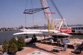 The Concorde, the fastest passenger jet in the world in its heyday, is lifted off the flight deck of the Intrepid Air &amp; Space Museum where it has been a popular attraction since its last flight in 2003. It heads to the Brooklyn Navy for a three month rebab. Photo: Beau Matic