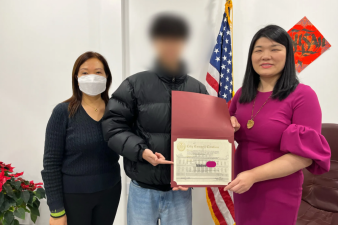 One of the Brooklyn teens who called 911 about the subway arsonist was honored by his local Council member, Susan Zhuang (right). His face is blurred to protect his anonymity.