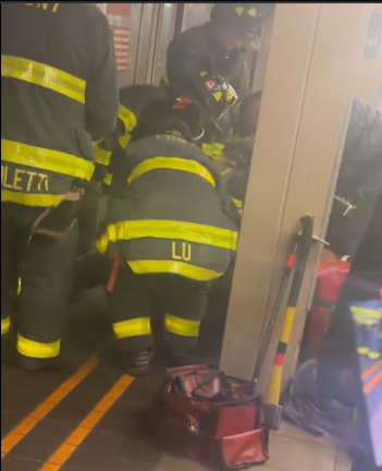 Joseph Lynskey, having just been run over by a 1 train, is lifted from the tracks by FDNY. He was rushed to Bellvue Hospital, where miraculously he survived and is currentrly recovering.