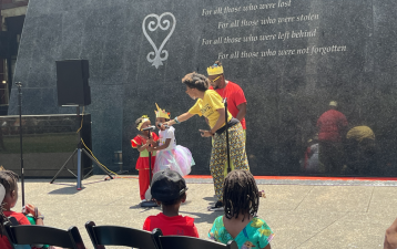 Wéma Ragophala, founder of arts organization Bridges, passes the mic to young children to join her in “Liberation Song.”