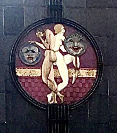 The comedy and tragedy plaque is part of the landmarked facade at the building at 2626 Broadway.