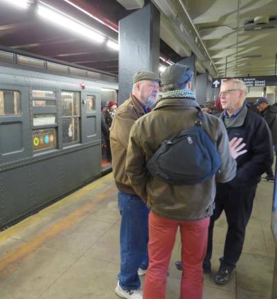 Three gentlemen stood on the platform at Second Avenue and Houston Street as the Holiday Nostalgia Train waits for a departure northwards to the 96th St/ 2nd Avenue.