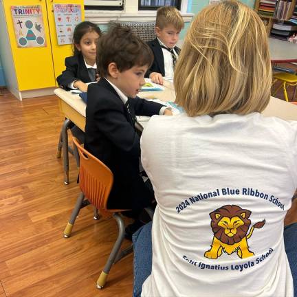 Students in their uniforms, teacher in a 2024 Blue Ribbon shirt: Roar!