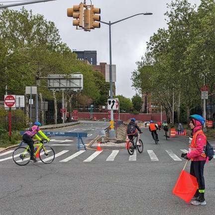 A bike marshall directs some of the 32,000 participants in the May 5 TD Bank Five Borough Bike Tour. Photo: Brian Berger