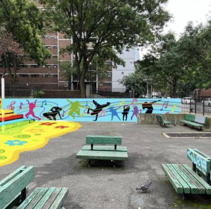 The rebuilt playbround at the NYCHA housing complex contains a mural that depicts the diverse population in the west side neighborhood.