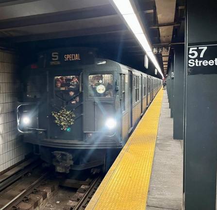 With faces hard pressed against the front glass, subway aficionados, young and old have scored the best location on the incoming Holiday Nostalgia Train. Unlike many other stations on the combined F/Q routing, the station at 57th and 6th had few passengers waiting to jump on the train as it headed north.