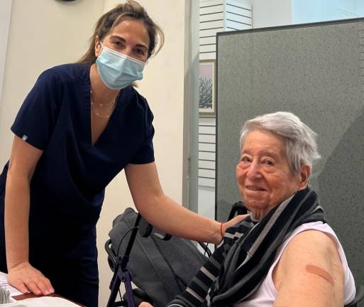 Ilana Yagudayev (left) a pharmacist and owner of Drug Mart on E. 86 Street and York Ave. administers a COVID booster shot to Helene Goldfarb at Assembly Member Rebecca Seawright’s in-office, no-cost clinic.