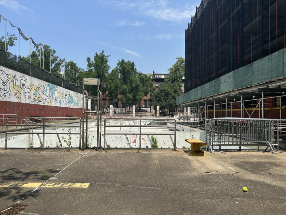 <b>The current state of the outdoor pool is derelict with remnants of construction work in the scaffolding that surrounds the building. To the left of the empty pool is the famous Keith Haring mural, made in 1987. </b>