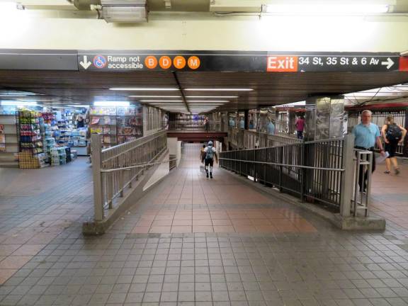 The ramp down to the Brooklyn-bound F train at the 34 St.-Harold Sq. subway station. 76 year-old Iqbal Ahmed was reportedly hoping to catch one on Sunday, August 13, but was derailed after allegedly being stabbed by 38 year-old David Trotman after denying his request for money.