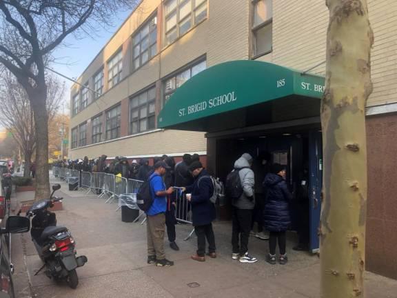 St. Brigid’s School, a shut-down Catholic elementary school in the East Village, drew long lines of asylum-seekers after the city used it as a processing center for people who exceeded 30 or 60 day shelter limits–and were seeking new placements. St. Brigid’s is the sole reprocessing center in the five boroughs.