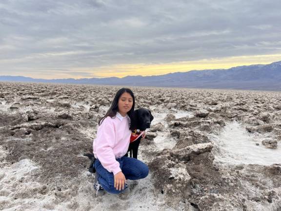 Lynn Wu, a Lighthouse Guild scholarship recipient, and her guide dog, Busby. Lynn lost her sight when she was six years old after a surgery impacted her unexpectedly.