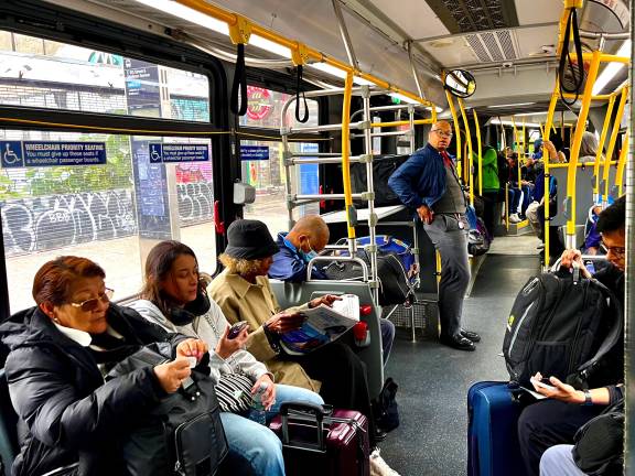 Riders on a recent SBS M60 bus in Manhattan have the option of getting a ride ticket at stops or using their OMNY cards or phones to pay. The MTA estimates that 40 percent of bus riders don’t pay.