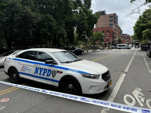 <b>Ave. “A” in the East Village was closed to traffic on July 12 while police investigated a double shooting inside Tompkins Sq. Park that left one man dead and another man wounded.</b> Photo: Keith J. Kelly