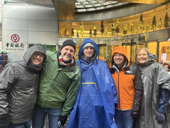 Matthew (green poncho) came from Ohio with his husband, some friends and his mom. He said the Thanksgiving Day parade was on his bucket list.