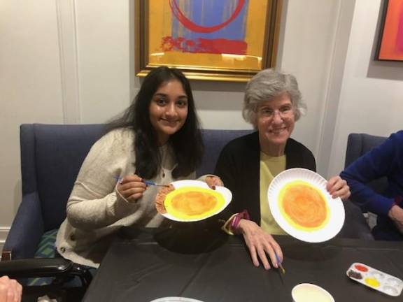 Volunteer Riya Bhat with resident Jill Majzlin.