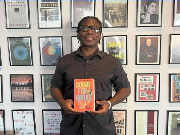 Navy veteran Alex Miller holding <i>Going For Broke</i>, which features his essay. Photo: Asher Fields