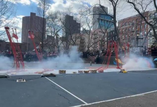 Red bands of fireworks dangle from a guide wire: Sara D. Roosevelt Park basketball court Jan. 29, 2025.