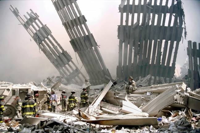 Photographer Peter Foley was able to capture firefigthers digging on the rubble because one of the lietenants from the West Side firehouse where Foley had lived for a year smuggled him on board a bus transporting firefigthers to search for survivors at Ground Zero the evening after the towers collapsed.