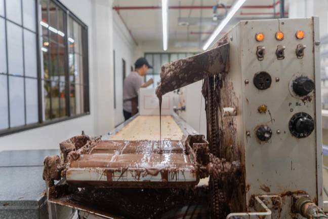 The new enrobing machine that can coat and cool over a 1000 chocolates an hour.