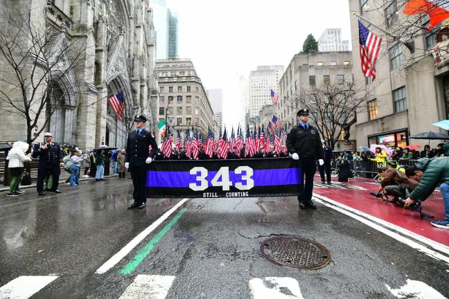 The FDNY contingent, as it passes St. Patrick’s catherdral always receives the largest ovation from spectators. Since 2002 the FDNY has handed out 343 American flags to commemorate the firefighters who died on 9/11. Since then, more than 390 additional firefighters have subsequently died of 9/11 related illnesses.