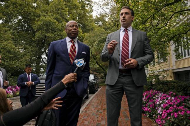 Eric Adams (left) with his high powered attorney Alex Spiro as he meets the press outside Gracie Mansion shortly after he was hit with a 57-page federal indictment alleging bribery, conspiracy and wire fraud.