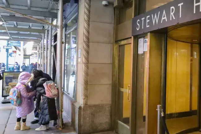 Migrant students walk to a bus stop outside the Stewart Hotel shelter in Midtown on the way to school, Jan. 24, 2025.