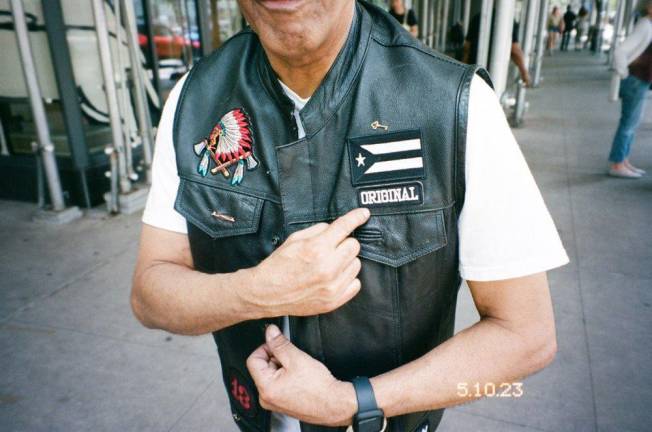 Felix Familia poses with his La West Side Familia vest.