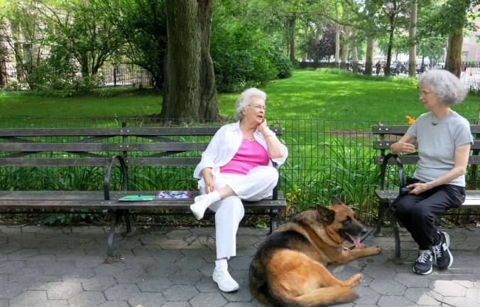 Mary Gissler, left, chats with Georgia Steele (and dog Midas) in front of the park. Photo by Sig Gissler