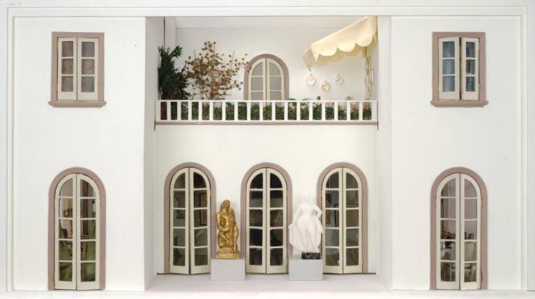 Exterior view of the Stettheimer Dollhouse, with balcony and patio. The house boasts 16 rooms, a ballroom, an elevator, and a fine art collection in miniature, as seen above.