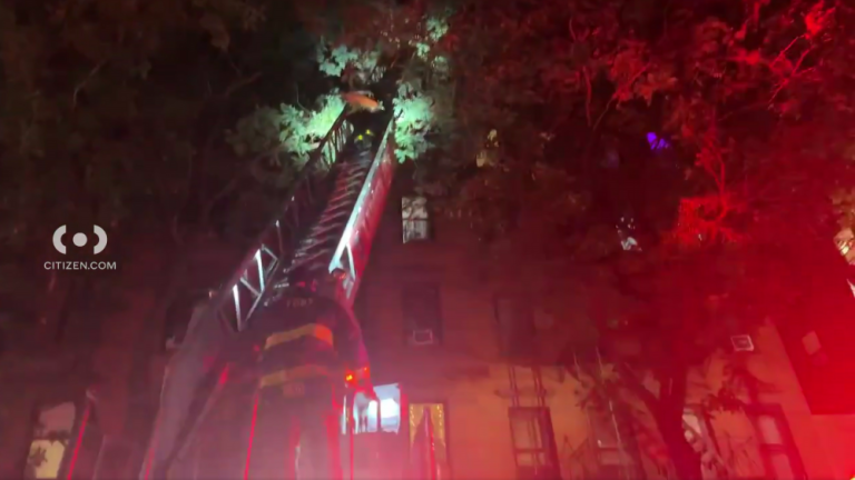 Two firefighters combat a fire in an Upper West Side apartment building on Oct. 12 in which one civilian was killed.