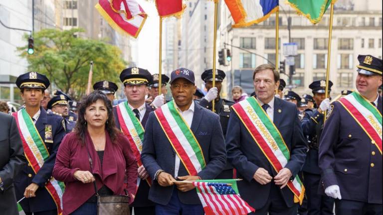 Mayor Eric Adams marches in a dual Mets - Yankees logo hat at the Columbus Day Parade; Interim NYPD Commissioner Thomas Donlon stands to Mayor’s left (to the right in the photo).